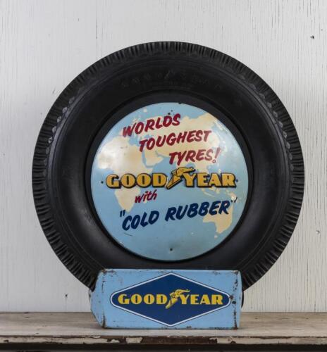 GOODYEAR: A circa 1960s Goodyear tyre with printed and embossed plastic sign on tin tyre stand, the tyre stand printed to lower right hand side: Standard Industries Pty Ltd Sydney 2.67, 74cm high overall