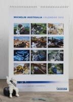MICHELIN: A circa 1990s figure of Bibendum seated on a tyre for dashboards and a 2012 Michelin promotional calendar, Bib 8.5cm high