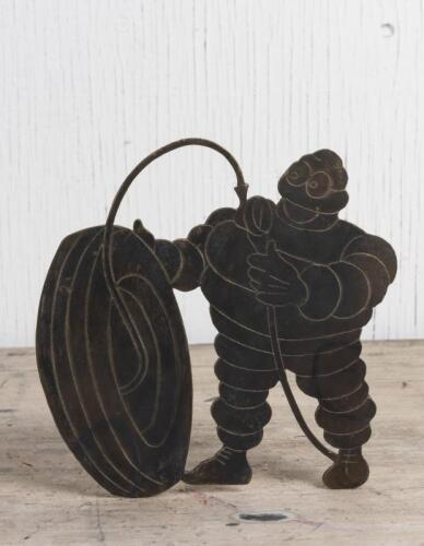 MICHELIN: A figure of Bibendum pumping a tyre cut from a brass sheet, 18 x 19cm