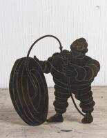 MICHELIN: A figure of Bibendum pumping a tyre cut from a brass sheet, 18 x 19cm