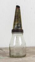 SINCLAIR: A Sinclair Opaline one pint embossed glass oil bottle with Shell tin pourer, the pourer heavily worn,