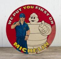 MICHELIN: A 1980s 'We Put You First On" tyre advertising sign on thick card, 42cm diameter