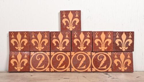 A set of thirteen late 19th century Minton ceramic tiles, comprising nine with a fleur-de-lys design and four with a 2 within a circle with trefoild exrending to the corners, impressed verso: MINTON & CO, PATENT, STOKE ON TRENT, 15 x 15cm