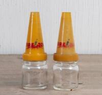 FIREZONE: Two small glass oil bottles with Firezone plastic oil pourers, 14cm high and 4.5cm diameter, both with cracks to pourers