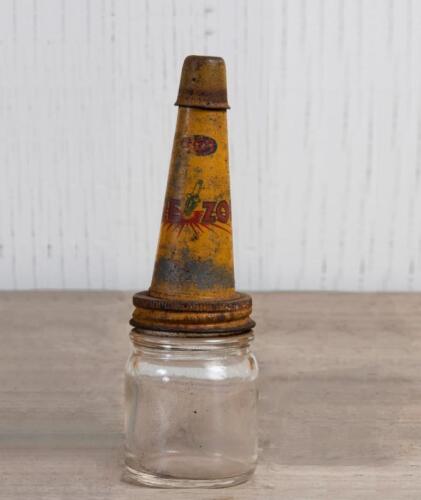 FIREZONE: A small glass oil bottle with early Firezone metal pourer and dust cap, 14cm high, 4.5cm diameter