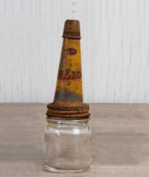 FIREZONE: A small glass oil bottle with early Firezone metal pourer and dust cap, 14cm high, 4.5cm diameter