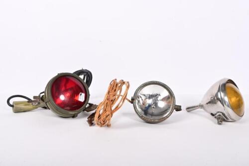 LAMP: An interesting S.H Thomson Mfg Co. USA pistol grip light in military livery and ruby lense, 21cm high, glass 10.5cm diameter, a work spotlight and another