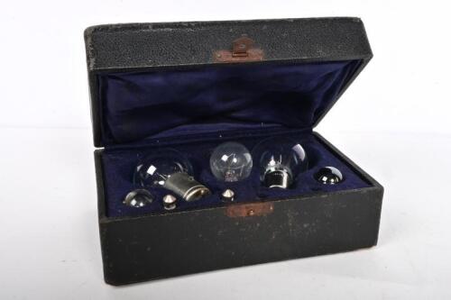 SPARE BULBS: A leather clad box with five spare bulbs, the box 7cm high, 16cm wide, 10cm deep