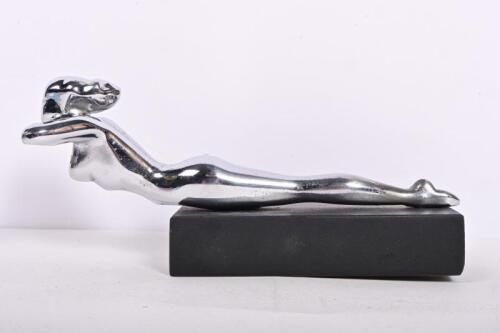 HOOD ORNAMENT: An American chrome hood ornament in the form of a lady in prone position, mounted on wood stand, 24cm long, 10.5 high