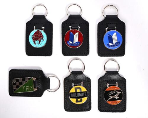 TRIUMPH: A collection of six&nbsp;unused near new Truimph / Dolomite / Stag / TR7 enameled key rings