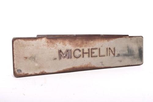 MICHELIN: A circa 1920s embossed Michelin tyre repair tin, 30.5cm wide