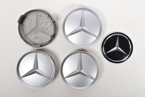 MERCEDES: A set of four 1970/80s Mercedes wheel inserts, 7.5cm diameter and a steering wheel logo insert, 6cm diameter