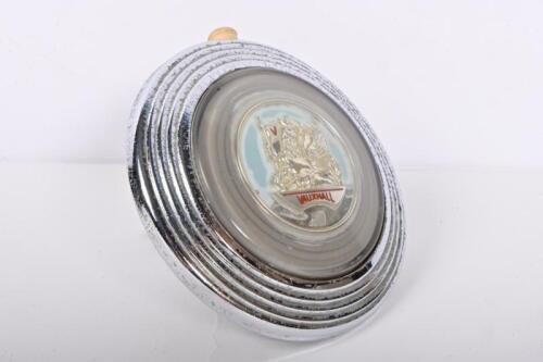 VAUXHALL: A Vauxhall steering wheel horn press and indicator lever, 12cm diameter