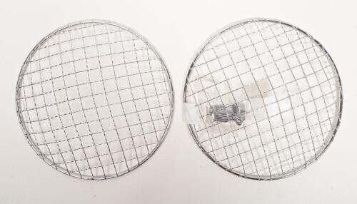 HEADLIGHT COVERS: A pair of stone guard headlight covers, with fastening clips, 18cm diameter