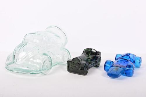 GLASS CARS: Three glass cars including VW Beetle cookie jar, with two AVON after shave bottles one a 'STRAIGHT EIGHT' in form of classic car, other a racing car.