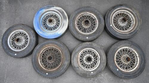 WIRE WHEELS: A Collection of seven mainly 13 and14 inch' various wire wheels with hard tires, one painted blue with mobil cushion nylon tire