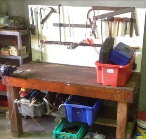 WORKSHOP: A large timber work bench, backing board and miscellaneous hand and electric tools