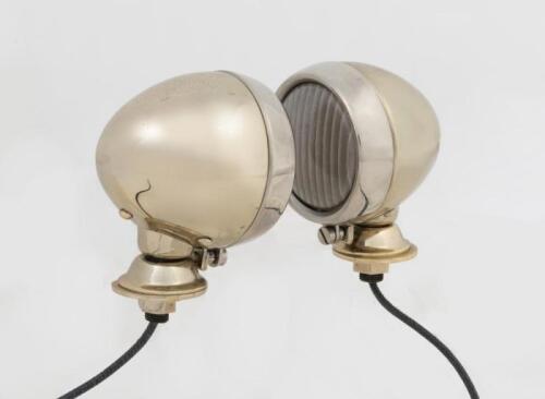 LAMPS: A pair of English NOS side lamps in brass and nickel plate, 9cm high x 5.5cm wide, internal ribbed convex glass 5.5cm diameter.