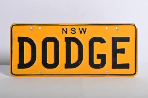 DODGE: A single 'DODGE' yellow and black number plate. New South Wales, no right to display