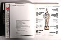 INDYCAR: Three publications related to IndyCar. 'INDY 500 - A Great American Tradition' hardcover book by Tom Carnegie - 3