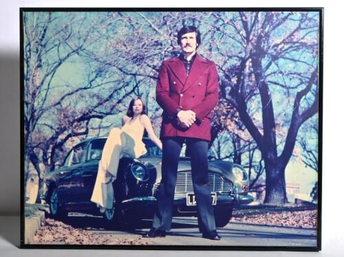 BOND: A colour picture of George Lazenby standing with an Aston Martin DB4 Vantage. Picture taken in Melbourne