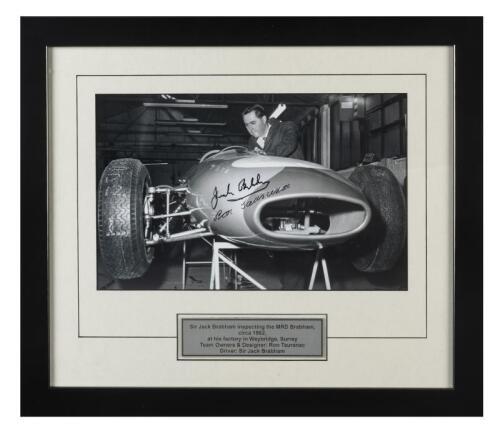 BRABHAM: A mounted black and white image of Sir Jack Brabham inspecting the MRD Brabham at his factory in Weybridge, Surrey, circa 1962. Image signed by team owners Sir Jack Brabham & designer Ron Tauranac
