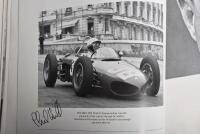 GRAND PRIX: 'THE GRAND PRIX DRIVERS' softcover book. Book signed by 10 World Champions and 5 Grand Prix winners. Signatures include Juan Manuel Fangio, Denis Hulme, Alan Jones, Rene Arnoux, Stirling Moss & Patrick Tambay. Superb signature set - 11