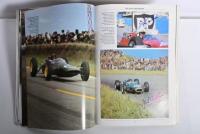 GRAND PRIX: 'THE GRAND PRIX DRIVERS' softcover book. Book signed by 10 World Champions and 5 Grand Prix winners. Signatures include Juan Manuel Fangio, Denis Hulme, Alan Jones, Rene Arnoux, Stirling Moss & Patrick Tambay. Superb signature set - 20