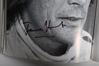 GRAND PRIX: 'THE GRAND PRIX DRIVERS' softcover book. Book signed by 10 World Champions and 5 Grand Prix winners. Signatures include Juan Manuel Fangio, Denis Hulme, Alan Jones, Rene Arnoux, Stirling Moss & Patrick Tambay. Superb signature set - 26