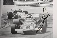 GRAND PRIX: 'THE GRAND PRIX DRIVERS' softcover book. Book signed by 10 World Champions and 5 Grand Prix winners. Signatures include Juan Manuel Fangio, Denis Hulme, Alan Jones, Rene Arnoux, Stirling Moss & Patrick Tambay. Superb signature set - 28