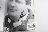 GRAND PRIX: 'THE GRAND PRIX DRIVERS' softcover book. Book signed by 10 World Champions and 5 Grand Prix winners. Signatures include Juan Manuel Fangio, Denis Hulme, Alan Jones, Rene Arnoux, Stirling Moss & Patrick Tambay. Superb signature set - 31