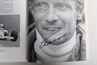GRAND PRIX: 'THE GRAND PRIX DRIVERS' softcover book. Book signed by 10 World Champions and 5 Grand Prix winners. Signatures include Juan Manuel Fangio, Denis Hulme, Alan Jones, Rene Arnoux, Stirling Moss & Patrick Tambay. Superb signature set - 36