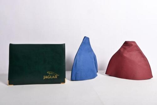 JAGUAR: Three Jaguar related items. 1990's Jaguar set of 'Vehicle Care' and 'Driver's Handbook' booklets. Gear lever leather covers