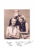 PAUL HOGAN SHOW: A black and white picture from The Paul Hogan Show depicting Paul Hogan, Delvene Delaney, and John Cornell. Autographed by all 3 members.