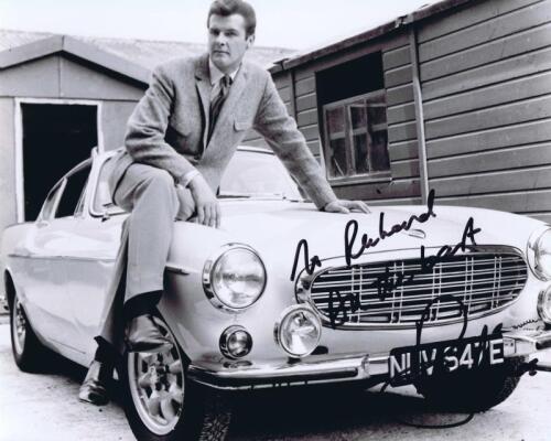 THE SAINT: A black and white picture depicting 'The Saint' Roger Moore and the Volvo P1800 coupe, autographed by Roger Moore.