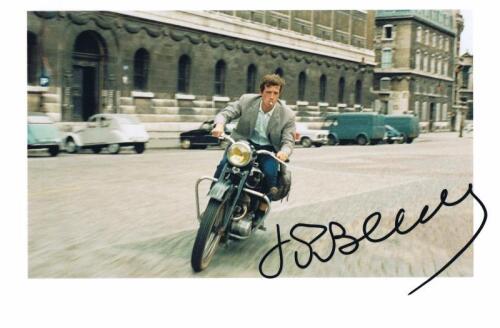 THE MAN FROM RIO: A colour picture from 'The Man from Rio' featuring Jean Paul Belmondo on motorcycle, autographed by Belmondo