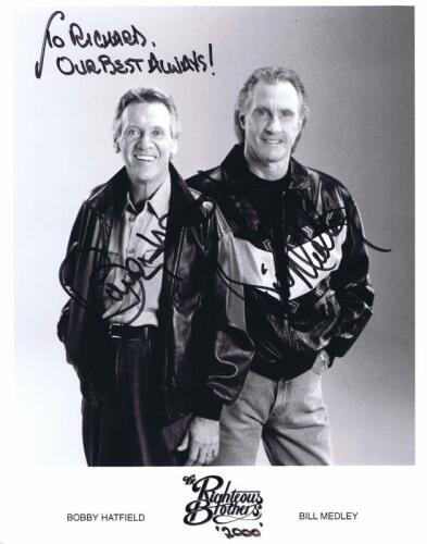 THE RIGHTEOUS BROTHERS: A black and white publicity picture card featuring 'The Righteous Brothers'. Card signed by band members Bobby Hatfield and Bill Medley