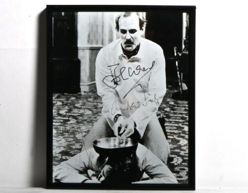 FAWLTY TOWERS: A black and white picture from Fawlty Towers, autographed by both John Cleese and Andrew Sachs, framed and glazed&nbsp;