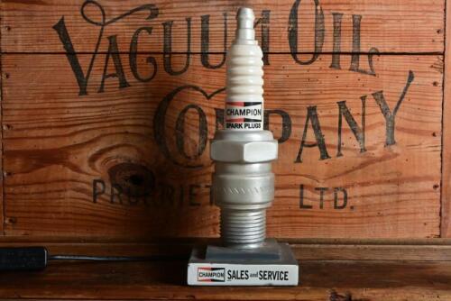 CHAMPION: A decorative circa 1980s point of sale countertop illuminated spark plug, 29cm high, later cord, working