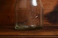 CASTROL: A 1940/50s "Castrol" embossed one imperial pint oil bottle, with late 20th century "Castrol XXL 40-50 MS" tin pourer and dust cover - 2