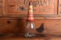 SHELL: A circa 1930s "Shell" embossed one imperial pint oil bottle, with circa 1950s "SHell 40 X-100" tin pourer and dust cover