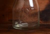 ATLANTIC: An early "Atlantic Union Oil Company" embossed one pint oil bottle, with original "Atlantic Heavy SAE 40" tin pourer and dust cover, with rivet air hole - 5