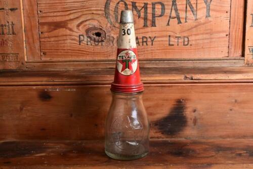 TEXACO: A mid 20th century "Texaco" embossed one pint oil bottle, with original mid 20th century "Texaco 30" tin pourer and dust cover, with rivet air hole