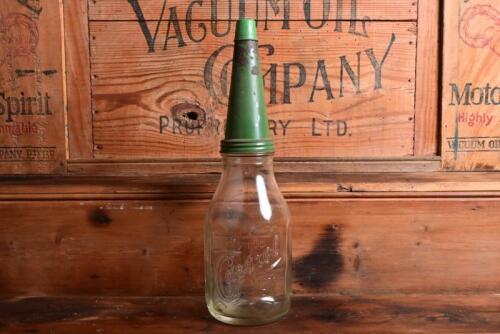 CASTROL: A 1940/50s "Castrol" embossed one imperial quart oil bottle, with green tin pourer and dust cover