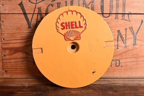SHELL: A 1930s cast metal petrol station tank cover plate, re-painted, 26.5cm diameter