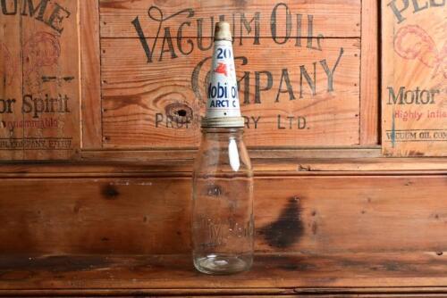 MOBIL: A circa 1930-50s "Mobiloil" embossed imperial one quart oil bottle, with circa 1930-50s "Mobiloil Arctic" tin pourer and dust cover (updated description)