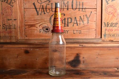 SHELL: A circa 1930s "Shell" embossed one imperial pint oil bottle, with a 1950s "SAE 20 Silver Shell Motor Oil" tin pourer and dust cover (updated description)