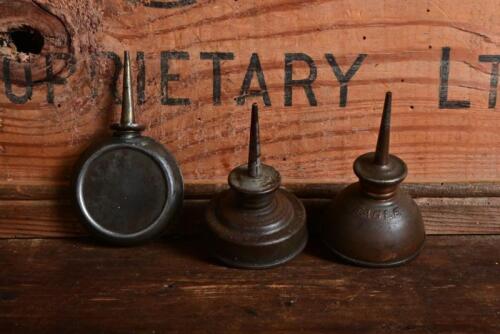 OLIER: Three small oilers, one with embossed lettering