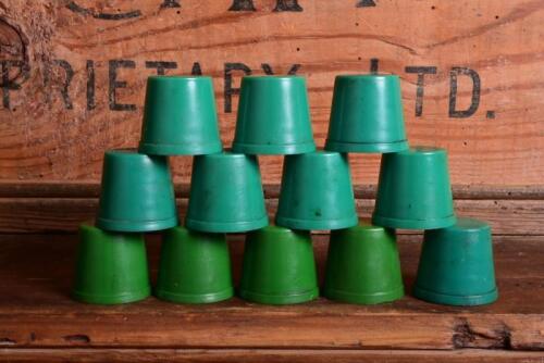 CAPS: A dozen circa 1970s oil bottle caps, in two tones of green