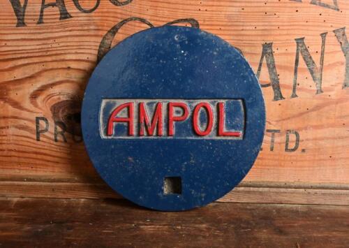 AMPOL: A cast metal Ampol petrol station tank cover, 19.5cm diameter